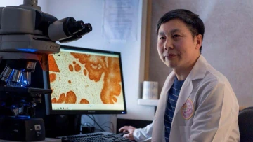 [Cheng Wang, PhD, in his lab at Massachusetts General Hospital in Boston]