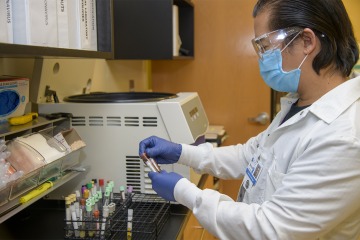 Phlebotomist and lab manager Bruce Cimafranca prepares to centrifuge blood specimens at a Winslow, Ariz, medical center. The specimens are then packaged and couriered back to the lab in Tucson for testing.