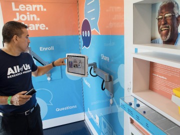 A man interacts with a video kiosk