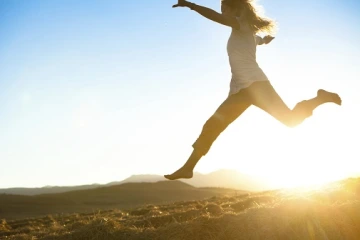 Woman running at sunset