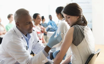 Female teenager getting a vaccination