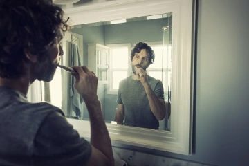 Male brushing teeth