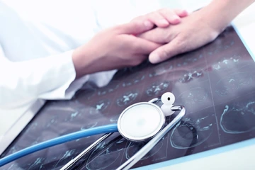 Doctor comforting patient in his office
