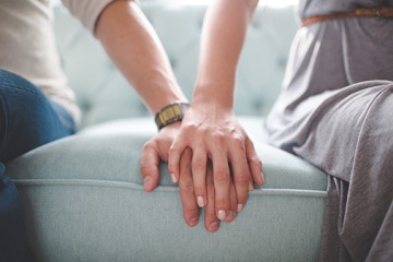 Male and female holding hands
