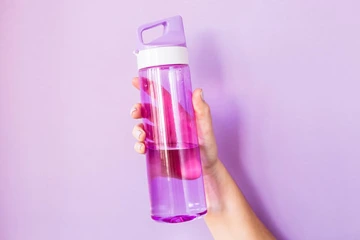 Close-up of a hand holding a water bottle