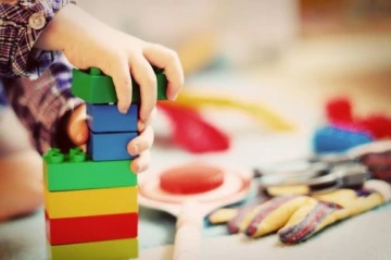 child playing with plastic building blocks