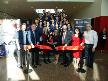 Gilbert campus ribbon cutting. Front row: Senior Vice President for Health Sciences Michael Dake, MD; College of Nursing Dean Ki Moore, PhD, RN, FAAN; Former Gilbert Mayor Jenn Daniels; UArizona President Robert C, Robbins, MD. Back rows: guests including the first BSN-IH cohort.