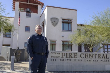 Man standing in front of the City of Tucson Fire Station