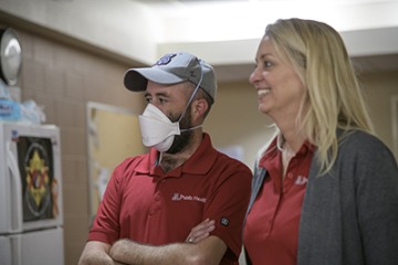 Jonathan Sexton, PhD, and Kelly Reynolds, PhD, watch as the Tucson Fire Department films a training video demonstrating proper infection control procedures for first responders.