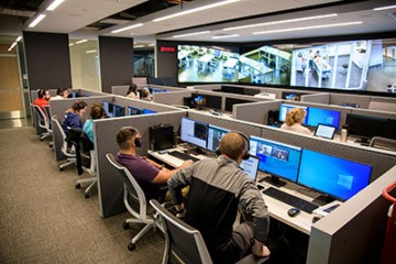 From an adjacent control room, SimDeck participants are observed on monitors