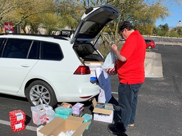 Michael Abecassis, MD, dean of College of Medicine – Tucson, sorts donations during the personal protective equipment drive.