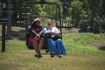 Diné College student Alyssa Joe (left) and program manager Kaitlyn Haskie enjoy a break from the heat while on a field trip to Mt. Lemmon as part of their neurosciences internship this summer.