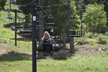 Kathleen E. Rodgers, PhD, professor of pharmacology at the College of Medicine –Tucson, rides the chairlift at Mt. Lemmon Ski Valley during an outing with Diné College students to the mountain.