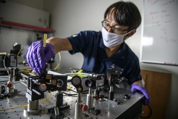 Dongkyun Kang, PhD, aligns laser optics to increase the light power of the portable, skin cancer diagnostic microscope in development.