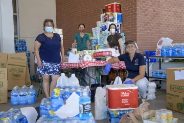 Cancer Center donations overwhelmed the staff set up to collect them, and an extra room in the Cancer Center was opened to store the donations before they were delivered to the Navajo Nation. Pictured from left: Debbie Aguirre, Tiffani Begay, Margaret Briehl, PhD, and Maria Lluria-Prevatt, PhD.