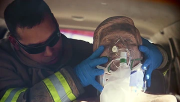 An emergency medical responder with Northwest Fire District practices treating a traumatic brain injury patient using EPIC treatment protocol. (Photo: Bob Demers/UA News)