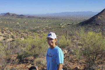 Dr. Nuño, pictured wearing an Adelante, Nuestro Futuro T-shirt on a hike in Tucson, says she finds being in nature a grounding experience. (Photo courtesy Velia Leybas Nuño)
