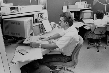 Dave Cantrell, former BioCom graphic design supervisor, using an early computer system to create slides for classroom lectures in the 1980s. This system was a predecessor to modern-day presentation graphics software.