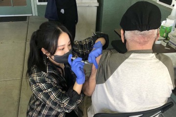 PharmD student Lisa Wan administers a Moderna vaccine to a resident of a senior living facility outside Phoenix.