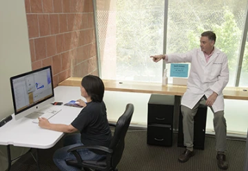 Makiko Watanabe, DVM, PhD (left), and Janko Nikolich-Žugich, MD, PhD (right), review the results of a preliminary assay that sheds light on the immune response to the virus that causes COVID-19.