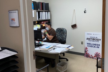 Jewels Parker, lab supervisor at a health care center outside of Phoenix, in her office with antibody testing signage delivered by Dan Derksen, MD.