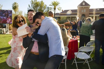 Aaron Masjedi is sandwich-hugged by his mother, Shiva Mahboob, and younger brother Eli Masjedi, after finding out he was matched with the University of Southern California during the UArizona College of Medicine – Tucson 2022 Match Day event on the lawn west of Old Main.