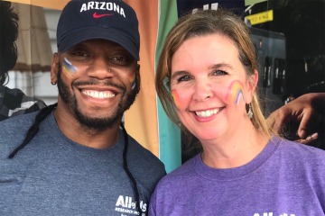 Carrie Whitten Simmons (right), senior marketing, communications and engagement manager for the All of Us UArizona – Banner Health, and Tony Wheaton, engagement coordinator, pause for a photo while working at the All of Us table at an event. 