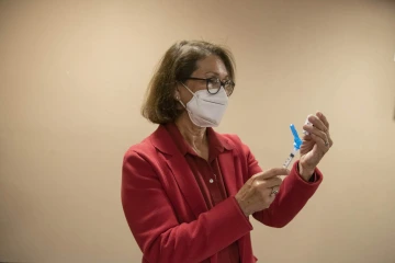 Cecilia Rosales, MD, MS, associate dean for community engagement and outreach at the UArizona Zuckerman College of Public Health, helps prepare vaccines at the Consulate of Mexico in Douglas, Arizona, as part of a MOVE UP clinic hosted by UArizona Health Sciences.