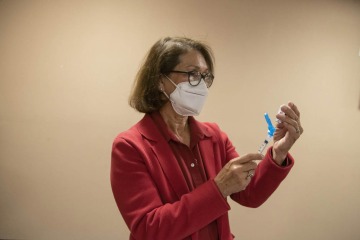 Cecilia Rosales, MD, MS, associate dean for of community engagement and outreach at the Zuckerman College of Public Health, prepares vaccines at the Consulate of Mexico in Douglas, Arizona.