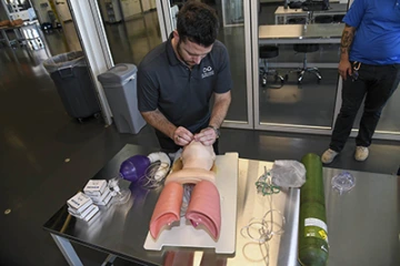 A local substance abuse rehab facility staff member applies what he learned during hands-on overdose training offered by ASTEC.