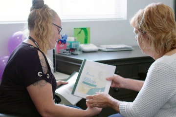 Two women looking at document