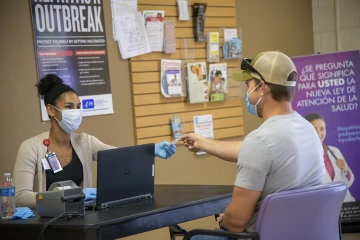 Alexandria Chaput, a research specialist at the College of Medicine – Tucson, checks Jacob Smith in for his appointment to receive the COVID-19 antibody test in early May. 