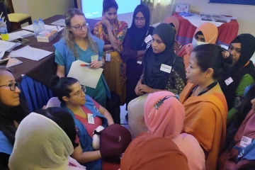 A group of clinicians take part in obstetrics basic life support training at a Rohingya refugee camp in Bangladesh.