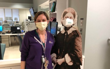 Samantha Alessi, MSN, poses with a picture of Florence Nightingale, considered the founder of modern nursing, while working at New York University Langone Health earlier this year.