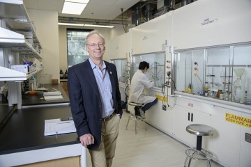 Rick G. Schnellmann, PhD, stands in front of the one of the new chemistry laboratories in the expanded Skaggs Center.
