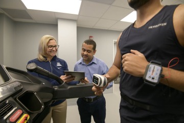 From left: Jennifer Barton, PhD, and Dr. Almeida check the data being collected from a study participant as he runs on a treadmill in the Sensor Lab.