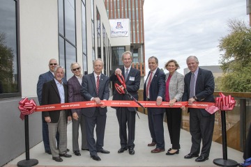 (From left) J.P. Roczniak, University of Arizona Foundation President and CEO; donor Richard Katz; donor R. Ken Coit; Rick Schnellmann, PhD, dean of the Coit College of Pharmacy; Ronny Cutshall, president of The ALSAM Foundation; Michael D. Dake, MD, senior vice president for the University of Arizona Health Sciences; Liesl Folks, PhD, MBA, University of Arizona Provost; and University of Arizona President Robert C. Robbins, MD, perform a ribbon-cutting to open the renovated and expanded Skaggs Center on Fe