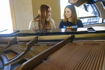 Picking up a new hobby or polishing up an older skill can help teens build self-reliance, a sense of autonomy that equips them to face new challenges. Here, two sisters play piano.