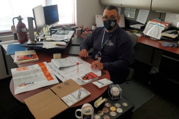 Tucson Fire Department Captain John Gulotta prepares for a nasal swab, which will be returned to researchers in the supplied packaging via Federal Express. (Photo: Tucson Fire Department Safety)