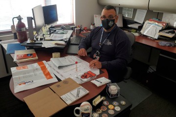 Tucson Fire Department Captain John Gulotta prepares for a nasal swab, which will be returned to researchers in the supplied packaging via Federal Express. (Photo: Tucson Fire Department Safety)