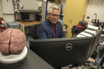 Tommy K. Begay, PhD, MPH, in his lab at the College of Medicine – Tucson, says his work today on the impact of childhood stress is connected to the trauma Native people have experienced over the centuries.