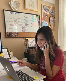 Dr. Cecilia Rosales, with Dr. Eduardo Gonzales (background), performing screenings at Arizona PRIDE Alliance event hosted by Chicanos Por La Causa at Corona Ranch, Phoenix. (Photo: University of Arizona/Alma Ramirez)