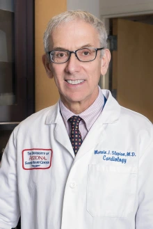 Portrait of Dr. Marvin J. Slepian wearing a white medical coat and tie. 