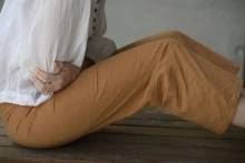 Woman in pain holding stomach