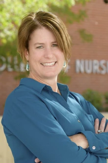 Portrait of Professor Helena Morrison, a smiling light-skinned woman with short dark hair.