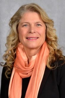 Portrait of Professor Ruth Taylor-Piliae, a smiling light skinned woman with long blonde hair.