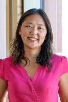 Dr. Alice Min Simpkins wearing a pink blouse.