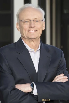 Portrait of Rick G. Schnellmann, PhD, standing outside smiling with his arms crossed in front of him. 