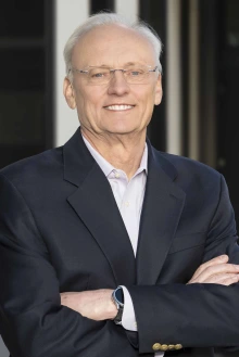 Portrait of Rick G. Schnellmann, PhD, standing with his arms folded in front of him.