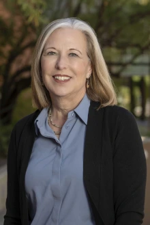 Portrait of Dr. Kristen Rundell smiling as she stands outside.